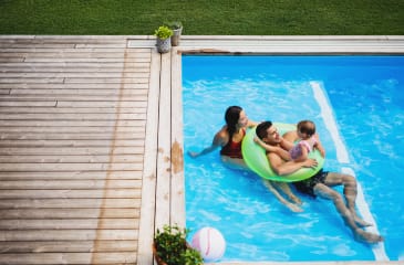 Family enjoying a pool in one of the inviting homes with pools from Jason Anson’s real estate listings, your ally in finding the perfect family home.