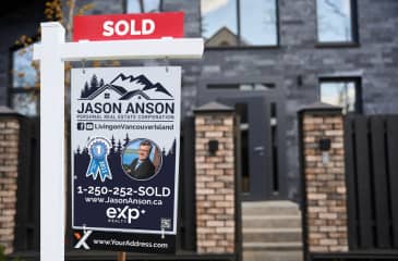 Sold sign on a property with agent Jason Anson's advertisement on Vancouver Island, signaling a successful real estate deal.