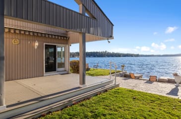 Waterfront deck of a contemporary home on Vancouver Island, with a clear view of the serene waters.
